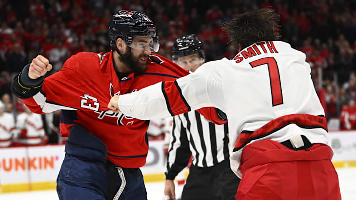 Mar 28, 2022; Washington, District of Columbia, USA; Washington Capitals right wing Tom Wilson (43) and Carolina Hurricanes defenseman Brendan Smith (7) fight during the third period at Capital One Arena. Mandatory Credit: Brad Mills-Imagn Images