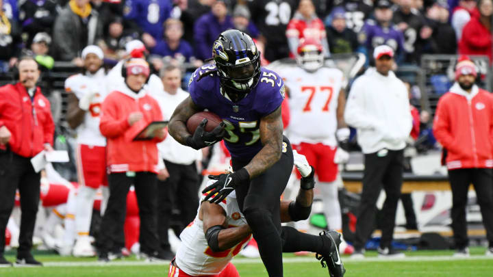 Jan 28, 2024; Baltimore, Maryland, USA; Baltimore Ravens running back Gus Edwards (35) runs with the ball against the Kansas City Chiefs during the first half in the AFC Championship football game at M&T Bank Stadium. Mandatory Credit: Tommy Gilligan-USA TODAY Sports