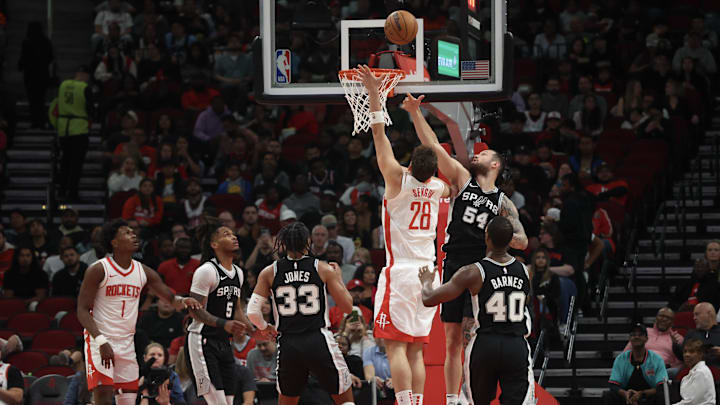 Oct 17, 2024; Houston, Texas, USA; Houston Rockets center Alperen Sengun (28) shoots against San Antonio Spurs forward Sandro Mamukelashvili (54) in the second quarter at Toyota Center. Mandatory Credit: Thomas Shea-Imagn Images