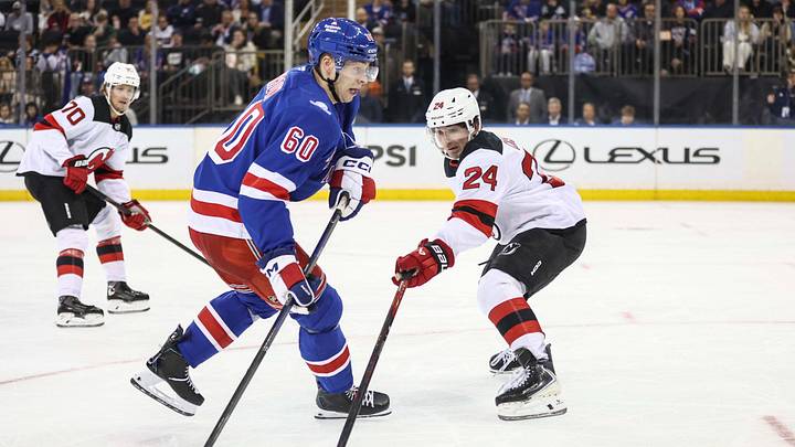 New York Rangers defenseman Scott Morrow (60) shoots past New Jersey Devils defenseman Seamus Casey (24) in the second period at Madison Square Garden.  Mandatory Credit: Wendell Cruz-Imagn Images
