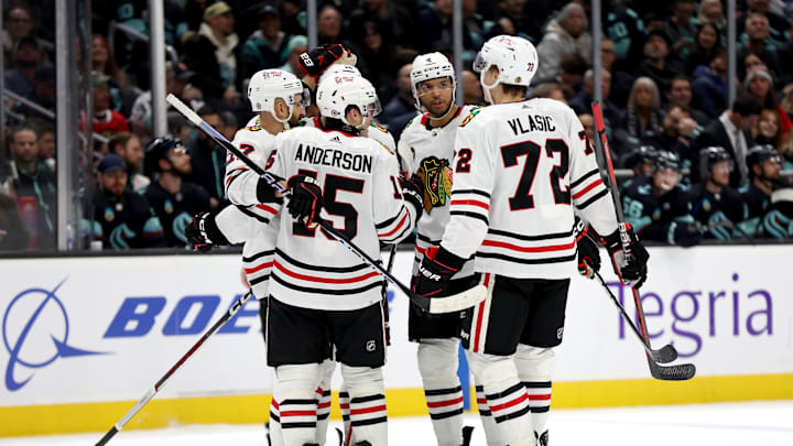 Joey Anderson and Alex Vlasic celebrate a goal with teammates