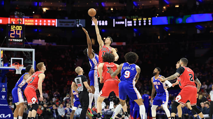 Feb 24, 2025; Philadelphia, Pennsylvania, USA; Chicago Bulls forward Zach Collins (12) and Philadelphia 76ers forward Guerschon Yabusele (28) tip off to start the game at Wells Fargo Center. Mandatory Credit: Bill Streicher-Imagn Images