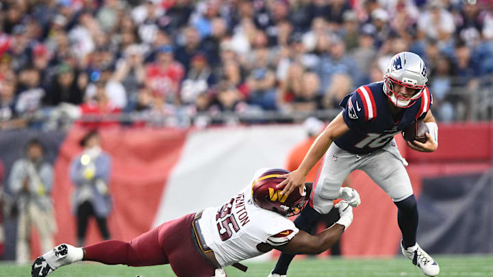 Aug 8, 2025; Foxborough, Massachusetts, USA; Washington Commanders safety Dominique Hampton (45) tackles New England Patriots quarterback Drake Maye (10) during the first half at Gillette Stadium. Mandatory Credit: Brian Fluharty-Imagn Images
