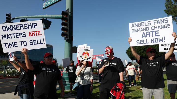 Los Angeles Angels fans gather outside Angel Stadium before the game between the Los Angeles Angels and the Texas Rangers to protest the Angels team owner Arte Moreno on May 23, 2026.