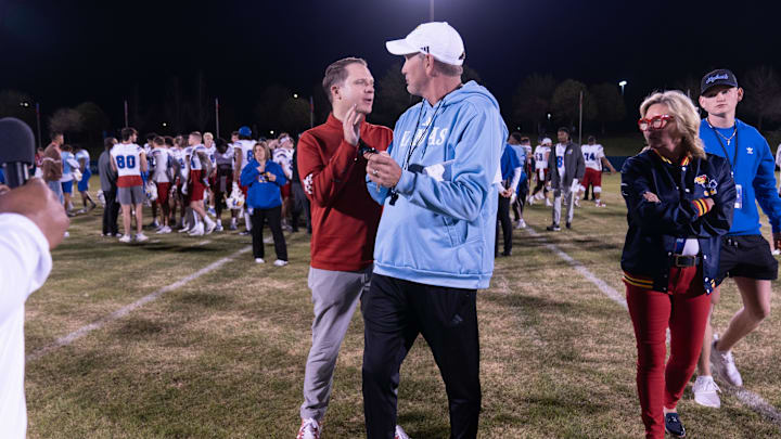 Kansas athletic director Travis Goff talks with coach Lance Leipold following Friday's Spring Showcase