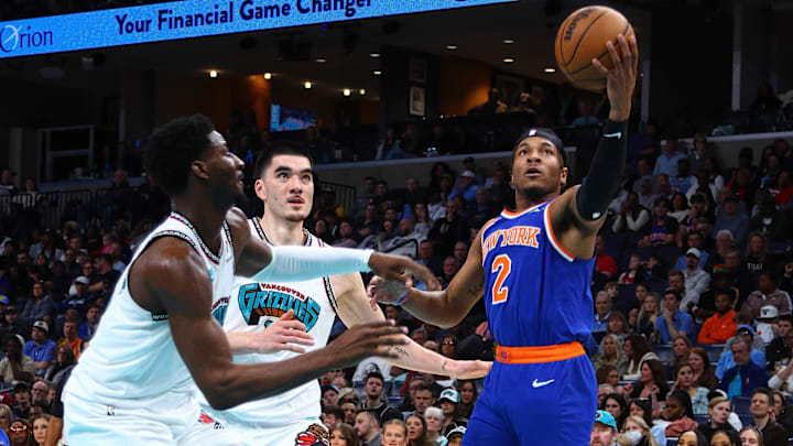 Feb 28, 2025; Memphis, Tennessee, USA; New York Knicks guard Miles McBride (2) shoots as Memphis Grizzlies forward Jaren Jackson Jr. (13) and center Zach Edey (14) defend during the second quarter at FedExForum. Mandatory Credit: Petre Thomas-Imagn Images
