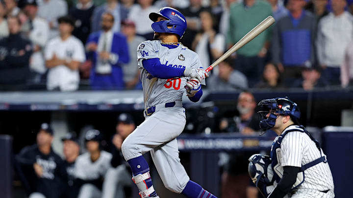 Oct 30, 2024; New York, New York, USA; Los Angeles Dodgers shortstop Mookie Betts (50) hits a sacrifice fly during the eighth inning against the New York Yankees in game four of the 2024 MLB World Series at Yankee Stadium. Mandatory Credit: Brad Penner-Imagn Images