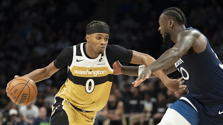 Nov 19, 2025; Minneapolis, Minnesota, USA; Washington Wizards guard Bilal Coulibaly (0) dribble the ball as Minnesota Timberwolves forward Julius Randle (30) plays defense in the second half at Target Center. Mandatory Credit: Jesse Johnson-Imagn Images