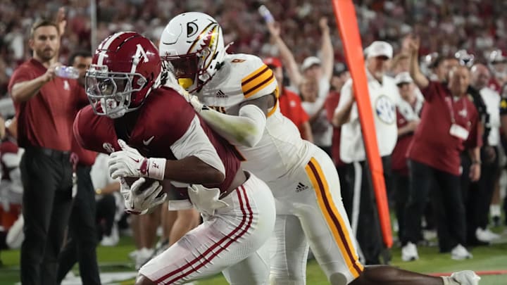 Sep 6, 2025; Tuscaloosa, Alabama, USA;  Alabama wide receiver Isaiah Horton (1) catches a pass and scores a touchdown with UL Monroe defensive back Carl Fauntroy (8) defending at Saban Field at Bryant-Denny Stadium. Mandatory Credit: Gary Cosby Jr.-Imagn Images