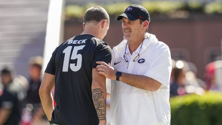 Sep 2, 2023; Athens, Georgia, USA; Georgia Bulldogs quarterback Carson Beck (15) and offensive coordinator Mike Bobo talk on the field before the game against the Tennessee Martin Skyhawks at Sanford Stadium. Mandatory Credit: Dale Zanine-USA TODAY Sports Sep 2, 2023; Athens, Georgia, USA; Georgia Bulldogs quarterback Carson Beck (15) and offensive coordinator Mike Bobo talk on the field before the game against the Tennessee Martin Skyhawks at Sanford Stadium. Mandatory Credit: Dale Zanine-USA TODAY Sports