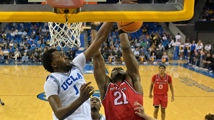 Feb 3, 2026; Los Angeles, California, USA;  UCLA Bruins forward Xavier Booker (1) blocks a shot by Rutgers Scarlet Knights center Emmanuel Ogbole (21) in the second half at Pauley Pavilion presented by Wescom Financial. Mandatory Credit: Jayne Kamin-Oncea-Imagn Images
