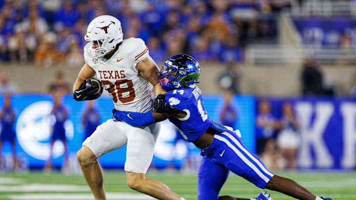 Texas tight end Jack Endries is tackled by a Kentucky defender.