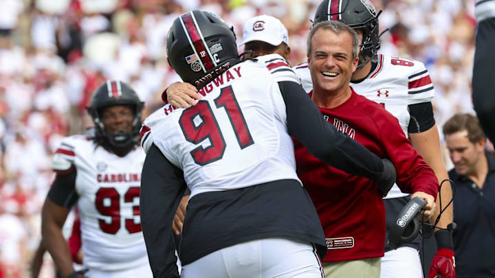 Oct 19, 2024; Norman, Oklahoma, USA;  South Carolina Gamecocks defensive tackle Tonka Hemingway (91) celebrates with South Carolina Gamecocks head coach Shane Beamer after returning a fumble for a touchdown during the first half against the Oklahoma Sooners at Gaylord Family-Oklahoma Memorial Stadium. Mandatory Credit: Kevin Jairaj-Imagn Images