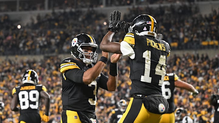 Oct 20, 2024; Pittsburgh, Pennsylvania, USA; Pittsburgh Steelers wide receiver George Pickens (14) celebrates an 11 yard touchdown pass with quarterback Russell Wilson (3) iagainst the New York Jets during the second quarter at Acrisure Stadium. Mandatory Credit: Barry Reeger-Imagn Images