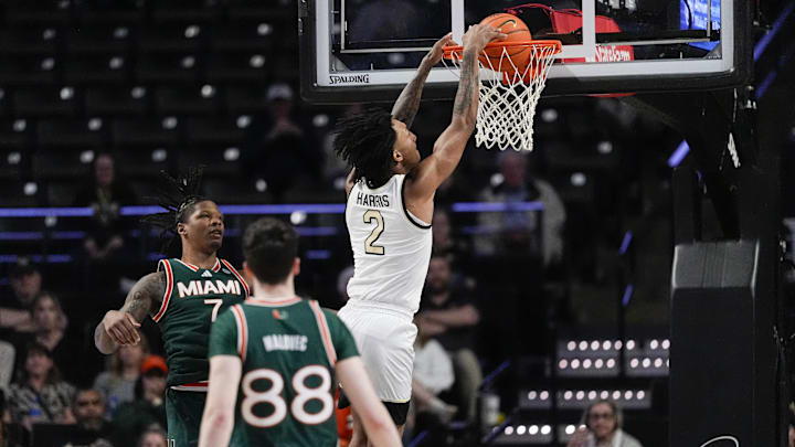 Jan 7, 2026; Winston-Salem, North Carolina, USA; Wake Forest Demon Deacons forward Juke Harris (2) dunks the ball past Miami (FL) Hurricanes forward Shelton Henderson (7) during the second half at Lawrence Joel Veterans Memorial Coliseum. Mandatory Credit: Jim Dedmon-Imagn Images