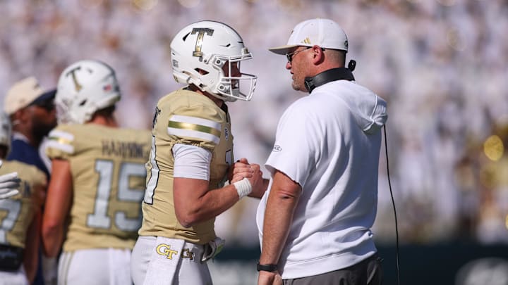Oct 25, 2025; Atlanta, Georgia, USA; Georgia Tech Yellow Jackets quarterback Haynes King (10) and head coach Brent Key celebrate after at touchdown against the Syracuse Orange in the fourth quarter at Bobby Dodd Stadium at Hyundai Field. Mandatory Credit: Brett Davis-Imagn Images
Oct 25, 2025; Atlanta, Georgia, USA; Georgia Tech Yellow Jackets quarterback Haynes King (10) and head coach Brent Key celebrate after at touchdown against the Syracuse Orange in the fourth quarter at Bobby Dodd Stadium at Hyundai Field. Mandatory Credit: Brett Davis-Imagn Images