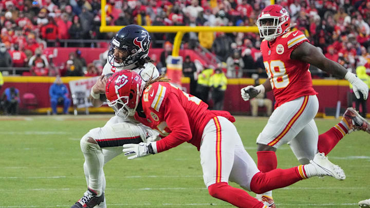 Jan 18, 2025; Kansas City, Missouri, USA; Houston Texans quarterback C.J. Stroud (7) is tackled by Kansas City Chiefs safety Justin Reid (20) during the second half of a 2025 AFC divisional round game at GEHA Field at Arrowhead Stadium. Mandatory Credit: Denny Medley-Imagn Images