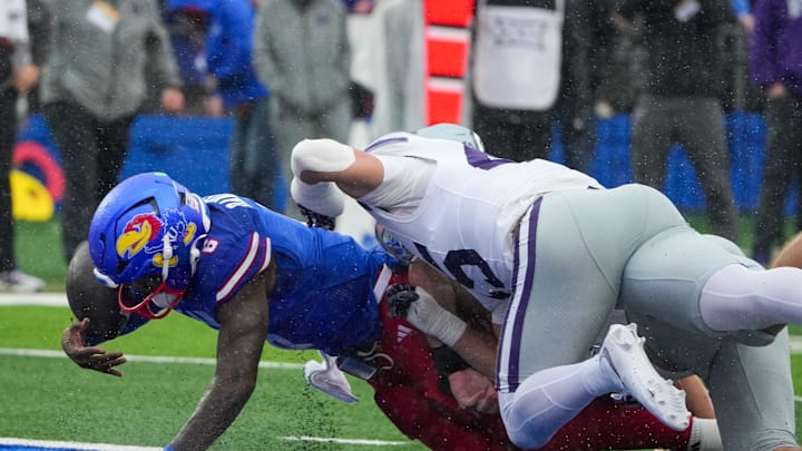 Oct 25, 2025; Lawrence, Kansas, USA;  Kansas Jayhawks quarterback Jalon Daniels (6) scores a touchdown as Kansas State Wildcats linebacker Austin Romaine (45) makes the tackle during the first half of the game at David Booth Kansas Memorial Stadium. Mandatory Credit: Denny Medley-Imagn Images Oct 25, 2025; Lawrence, Kansas, USA;  Kansas Jayhawks quarterback Jalon Daniels (6) scores a touchdown as Kansas State Wildcats linebacker Austin Romaine (45) makes the tackle during the first half of the game at David Booth Kansas Memorial Stadium. Mandatory Credit: Denny Medley-Imagn Images