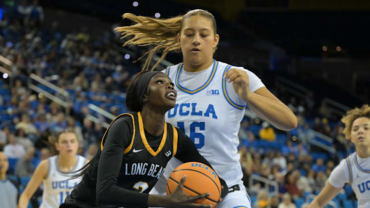 Dec 20, 2025; Los Angeles, California, USA; Long Beach State Beach forward Rosie Akot (2) is defended by UCLA Bruins forward Sienna Betts (16) as she drives to the basket during the second half at Pauley Pavilion presented by Wescom Financial. Mandatory Credit: Jayne Kamin-Oncea-Imagn Images