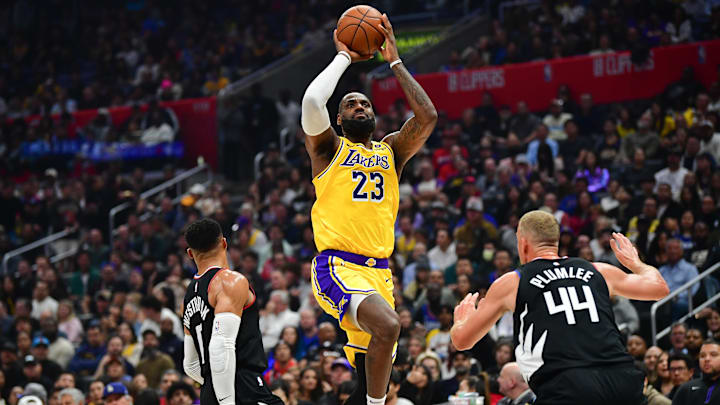 Feb 28, 2024; Los Angeles, California, USA; Los Angeles Lakers forward LeBron James (23) shoots against Los Angeles Clippers guard Russell Westbrook (0) and center Mason Plumlee (44) during the first half at Crypto.com Arena. Mandatory Credit: Gary A. Vasquez-Imagn Images
