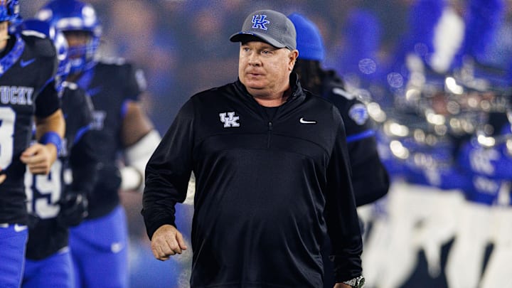 Oct 12, 2024; Lexington, Kentucky, USA; Kentucky Wildcats head coach Mark Stoops runs onto the field before a game against the Vanderbilt Commodores at Kroger Field. Mandatory Credit: Jordan Prather-Imagn Images