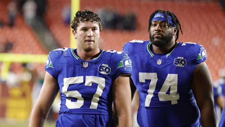 Nov 2, 2025; Landover, Maryland, USA; Seattle Seahawks linebacker Connor O'Toole (57) and Seahawks guard Josh Jones (74) walk off the field after defeating the Washington Commanders at Northwest Stadium. Mandatory Credit: Amber Searls-Imagn Images