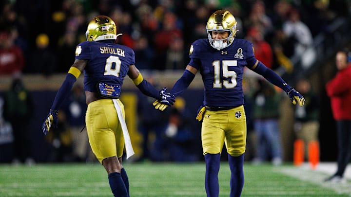 Notre Dame cornerback Leonard Moore (15) and safety Adon Shuler (8) celebrate getting a stop during the first round of the College Football Playoff between Notre Dame and Indiana at Notre Dame Stadium on Friday, Dec. 20, 2024, in South Bend.