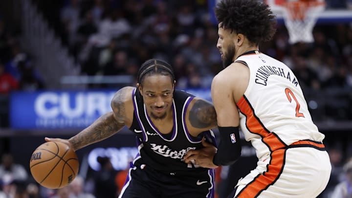 Apr 7, 2025; Detroit, Michigan, USA;  Sacramento Kings forward DeMar DeRozan (10) dribbles defended by Detroit Pistons guard Cade Cunningham (2) in the first half at Little Caesars Arena. Mandatory Credit: Rick Osentoski-Imagn Images