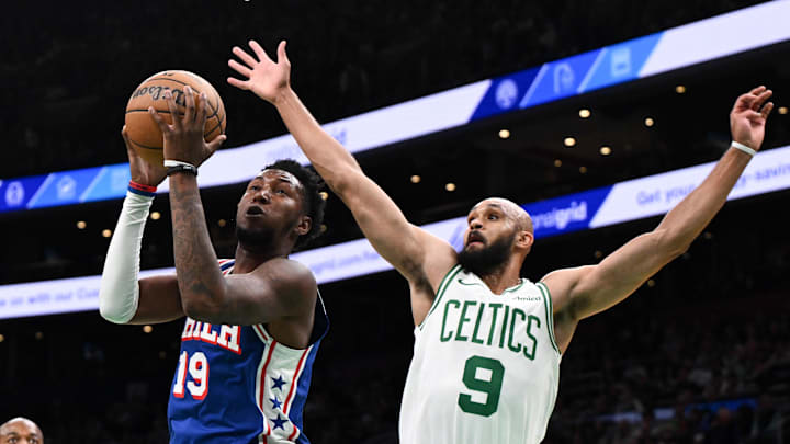Oct 12, 2024; Boston, Massachusetts, USA; Philadelphia 76ers forward Justin Edwards (19) drives to the basket against Boston Celtics guard Derrick White (9) during the first half at the TD Garden. Mandatory Credit: Brian Fluharty-Imagn Images