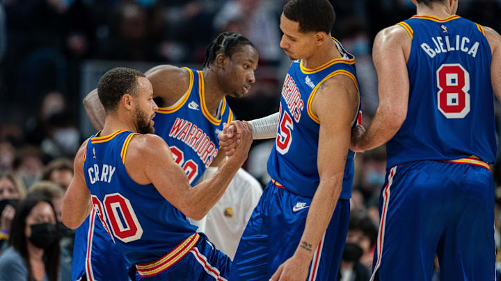 Dec 23, 2021; San Francisco, California, USA; Golden State Warriors forwards Juan Toscano-Anderson (95) and Jonathan Kuminga (00) assist guard Stephen Curry (30) off the floor during the third quarter against the Memphis Grizzlies at Chase Center. Mandatory Credit: Neville E. Guard-Imagn Images