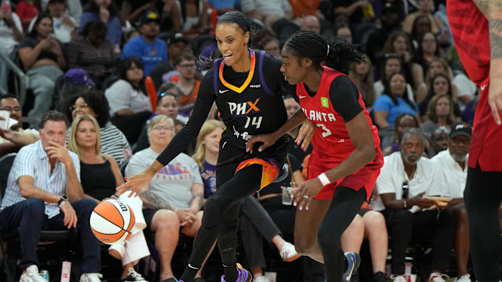 Jul 23, 2025; Phoenix, Arizona, USA; Phoenix Mercury forward DeWanna Bonner (14) drives on Atlanta Dream guard Jordin Canada (3) in the second half at Footprint Center. Mandatory Credit: Rick Scuteri-Imagn Images