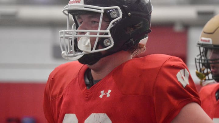 Green Bay Bay Port offensive lineman Aiden Dirksen jogs off the McClain Center Field during Wisconsin's summer camp on June 15.