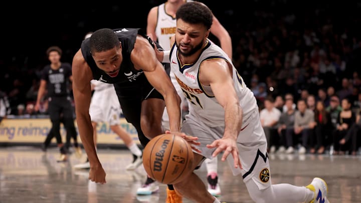 Dec 22, 2023; Brooklyn, New York, USA; Brooklyn Nets forward Mikal Bridges (1) and Denver Nuggets