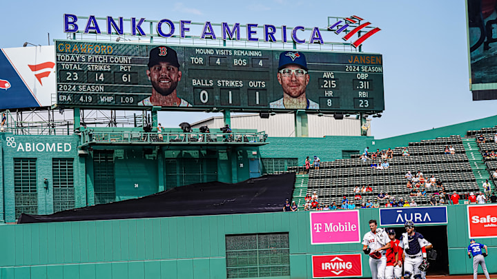 Aug 26, 2024; Boston, Massachusetts, USA; Boston Red Sox catcher Danny Jansen (28) makes his way to the dugout in a Boston Red Sox uniform while on the ball park score board when he was at bat during the postponed game back in June as a Toronto Blue Jays at Fenway Park. Mandatory Credit: David Butler II-USA TODAY Sports