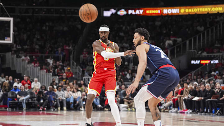 Mar 14, 2025; Atlanta, Georgia, USA; Atlanta Hawks guard Caris LeVert (3) passes the ball past LA Clippers guard Ben Simmons (25) during the first half at State Farm Arena. Mandatory Credit: Dale Zanine-Imagn Images