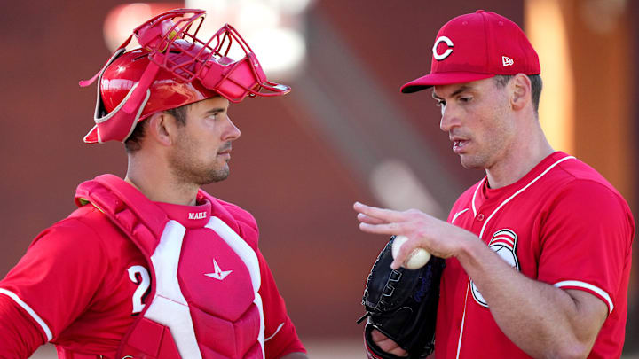 Cincinnati Reds catcher Luke Maile, left, and pitcher Brent Suter (31) talk after a bullpen session