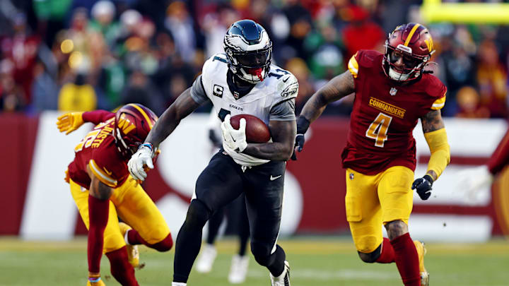 Dec 22, 2024; Landover, Maryland, USA; Philadelphia Eagles wide receiver A.J. Brown (11) runs the ball after a catch against Washington Commanders linebacker Frankie Luvu (4) during the fourth quarter at Northwest Stadium. Mandatory Credit: Peter Casey-Imagn Images