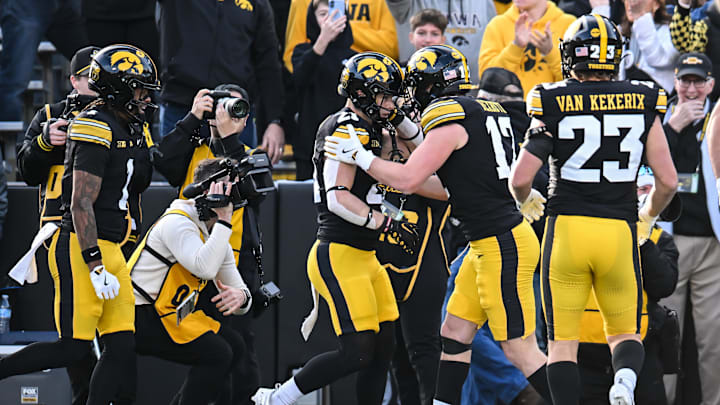Nov 22, 2025; Iowa City, Iowa, USA; Iowa Hawkeyes wide receiver Kaden Wetjen (21) reacts with wide receiver Alex Eichmann (17) and teammates after scoring a touchdown on a punt return against the Michigan State Spartans during the second quarter at Kinnick Stadium. Mandatory Credit: Jeffrey Becker-Imagn Images