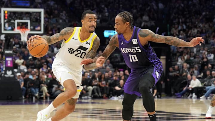 Dec 8, 2024; Sacramento, California, USA; Utah Jazz forward John Collins (20) dribbles against Sacramento Kings forward DeMar DeRozan (10) during the third quarter at Golden 1 Center. Mandatory Credit: Darren Yamashita-Imagn Images
