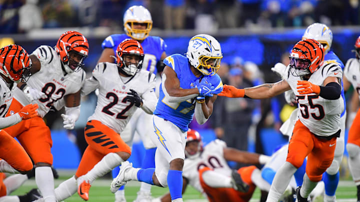 Nov 17, 2024; Inglewood, California, USA; Los Angeles Chargers running back J.K. Dobbins (27) runs the ball against Cincinnati Bengals linebacker Logan Wilson (55) during the second half at SoFi Stadium. Mandatory Credit: Gary A. Vasquez-Imagn Images Nov 17, 2024; Inglewood, California, USA; Los Angeles Chargers running back J.K. Dobbins (27) runs the ball against Cincinnati Bengals linebacker Logan Wilson (55) during the second half at SoFi Stadium. Mandatory Credit: Gary A. Vasquez-Imagn Images