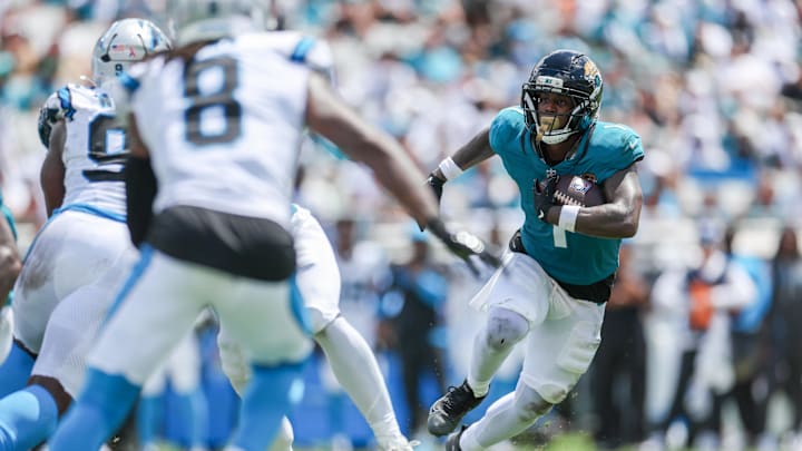 Sep 7, 2025; Jacksonville, Florida, USA; Jacksonville Jaguars running back Travis Etienne Jr. (1) carries the ball against the Carolina Panthers during the first half at EverBank Stadium. Mandatory Credit: Nathan Ray Seebeck-Imagn Images