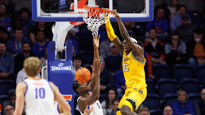 Jan 14, 2025; Gainesville, Florida, USA; Missouri Tigers guard Mark Mitchell (25) dunks the ball over Florida Gators center Rueben Chinyelu (9) during the second half at Exactech Arena at the Stephen C. O'Connell Center. Mandatory Credit: Matt Pendleton-Imagn Images