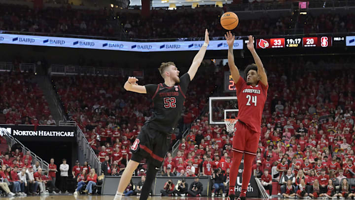 Mar 8, 2025; Louisville, Kentucky, USA;  Louisville Cardinals guard Chucky Hepburn (24) shoots against Stanford Cardinal forward Aidan Cammann (52) during the second half at KFC Yum! Center. Louisville defeated Stanford 68-48. Mandatory Credit: Jamie Rhodes-Imagn Images