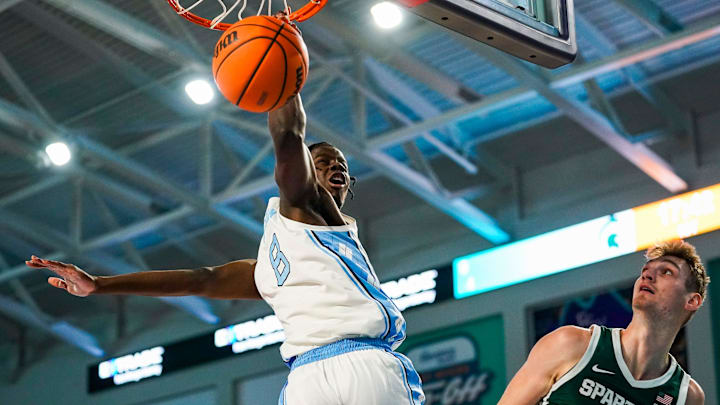 North Carolina Tar Heels forward Caleb Wilson (8) dunks the ball while twisting his body as Michigan State Spartans center Carson Cooper (15) guards him during the first half of the Fort Myers Tip-Off Beach Division game at Suncoast Credit Union Arena on Fort Myers, Fla., on Thursday, Nov. 27, 2025.