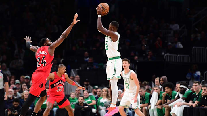 Oct 13, 2024; Boston, Massachusetts, USA;  Boston Celtics guard Lonnie Walker IV (12) shoots the ball past Toronto Raptors forward Bruno Fernando (24) during the second half at TD Garden. Mandatory Credit: Bob DeChiara-Imagn Images