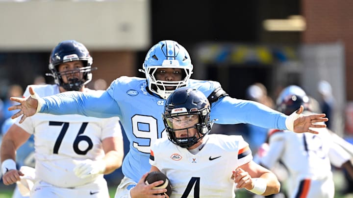 Oct 25, 2025; Chapel Hill, North Carolina, USA; North Carolina Tar Heels defensive lineman Isaiah Johnson (94) sacks Virginia Cavaliers quarterback Chandler Morris (4) in the second quarer at Kenan Stadium. Oct 25, 2025; Chapel Hill, North Carolina, USA; North Carolina Tar Heels defensive lineman Isaiah Johnson (94) sacks Virginia Cavaliers quarterback Chandler Morris (4) in the second quarer at Kenan Stadium.