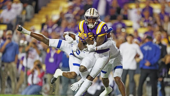 Nov 18, 2023; Baton Rouge, Louisiana, USA; LSU Tigers wide receiver Malik Nabers (8) hauls in a pass reception for a touchdown while being defended by Georgia State Panthers safety Jeremiah Johnson (6) (left) and cornerback Bryquice Brown (5) (right) in first quarter action at Tiger Stadium. Mandatory Credit: Matthew Dobbins-Imagn Images Nov 18, 2023; Baton Rouge, Louisiana, USA; LSU Tigers wide receiver Malik Nabers (8) hauls in a pass reception for a touchdown while being defended by Georgia State Panthers safety Jeremiah Johnson (6) (left) and cornerback Bryquice Brown (5) (right) in first quarter action at Tiger Stadium. Mandatory Credit: Matthew Dobbins-Imagn Images