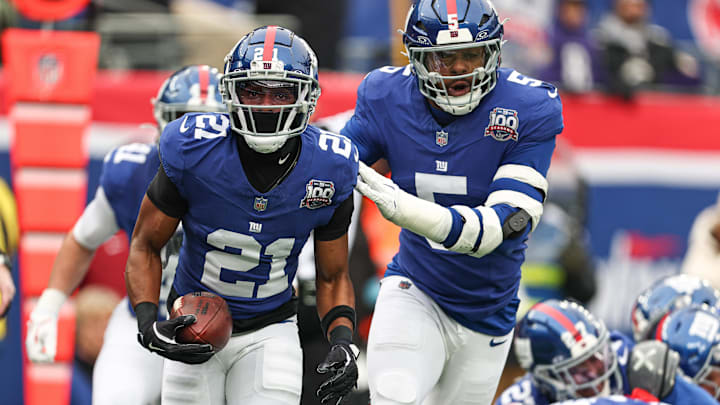 Dec 15, 2024; East Rutherford, New Jersey, USA; New York Giants cornerback Adoree' Jackson (21) celebrates with linebacker Kayvon Thibodeaux (5) after receiving a fumble against the Baltimore Ravens during the first quarter at MetLife Stadium. Mandatory Credit: Vincent Carchietta-Imagn Images