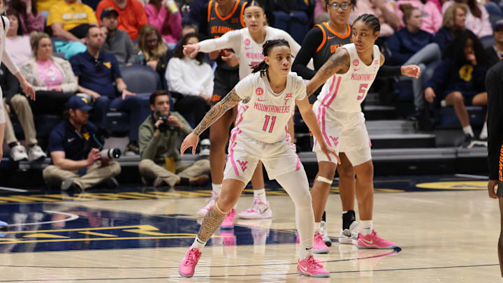 West Virginia University guards JJ Quinerly (11) and Sydney Shaw (5). 