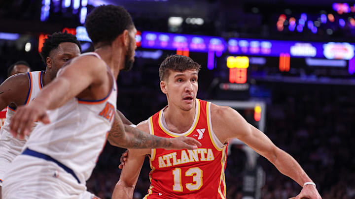 Jan 20, 2025; New York, New York, USA; Atlanta Hawks guard Bogdan Bogdanovic (13) is guarded by New York Knicks forward OG Anunoby (8) and guard Cameron Payne (1) during the second half at Madison Square Garden. Mandatory Credit: Vincent Carchietta-Imagn Images